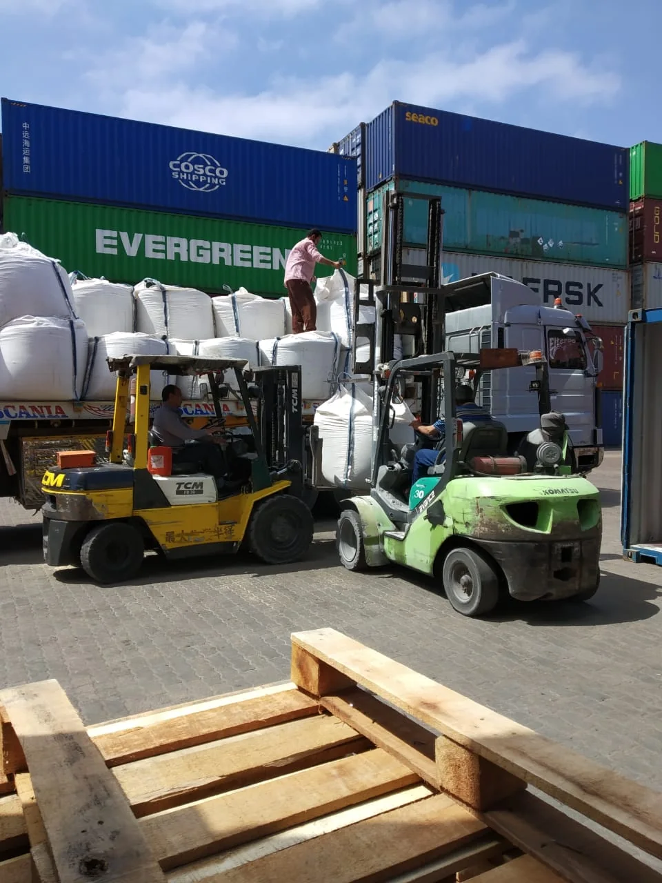 Forklifts handling jumbo bags in an export loading yard