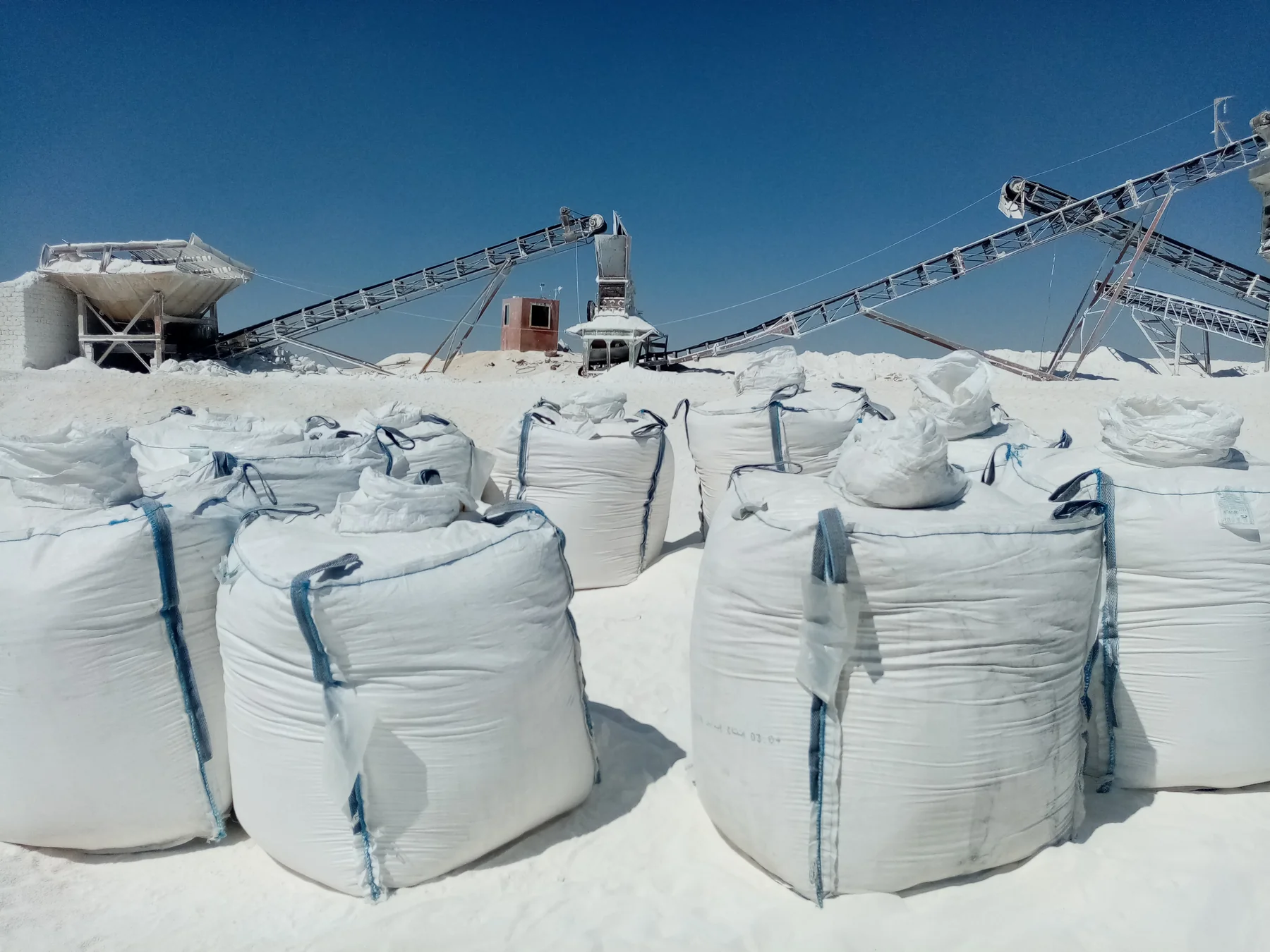 Big bags staged beside mineral processing equipment